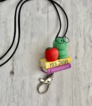 Load image into Gallery viewer, Teacher lanyard with books and caterpillar and apple
