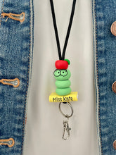 Load image into Gallery viewer, Teacher lanyard with bookworm, book and apple
